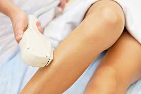 IPL hair removal treatment being applied to smooth legs with handheld device